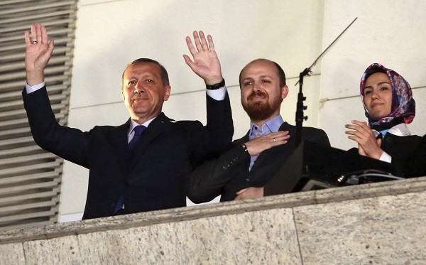Turkish Prime Minister Tayyip Erdogan (L), accompanied by his son Bilal and daughter Sumeyye, greets his supporters at the AK Party headquarters in Ankara March 30, 2014. Tayyip Erdogan declared victory in local polls that had become a referendum on his rule and said he would "enter the lair" of enemies who have accused him of corruption and leaked state secrets. "They will pay for this," he said. Erdogan spoke from a balcony at his AK Party headquarters to thousands of cheering supporters as early results showed it winning some 44-46 percent of the vote, and the opposition CHP trailing with 23-28 percent. Picture taken March 30. REUTERS/Umit Bektas (TURKEY - Tags: POLITICS ELECTIONS)