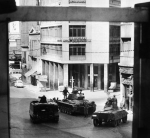 Greek army tanks and soldiers take position in Omnia Place, 27 April 1967, after the military coup of 4 colonels of the Greek army. On 21 April 1967, a group of right-wing army officers led by Brigadier Stylianos Pattakos and Colonels Georgios Papadopoulos and Nikolaos Makarezos seized power in a coup d'etat and installed a military junta, also called "The Regime of the Colonels”, that ended in 1974. / AFP PHOTO / VOTAVA / -