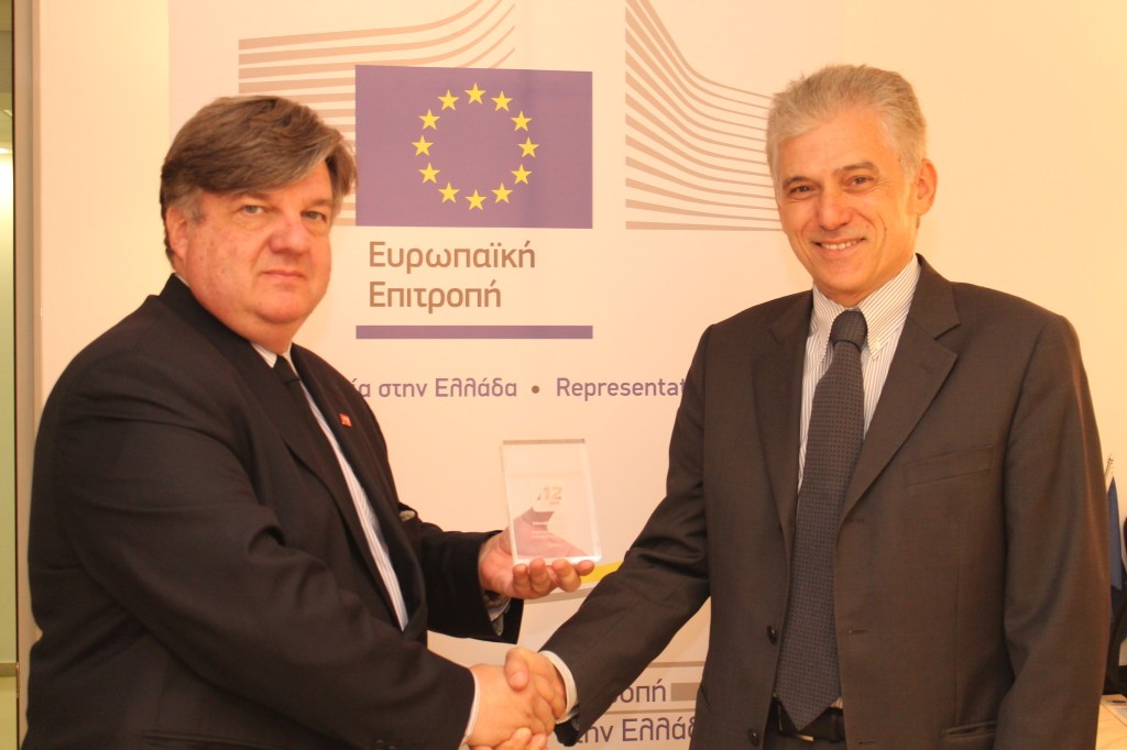 Mr. Carvounis receives the Outstanding Education on 112 Award for 2014 from Dr. Demitrios Pyrros, Chairman or the Advisory Committee of the European Emergency Number Association (EENA). The award honours the videos on the European Emergency call number 112 produced by the Representation.