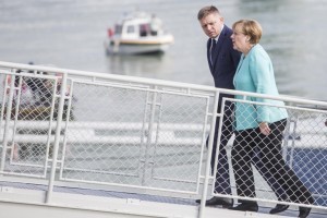Slovakia's Prime minister Robert Fico (L) and Germany's Chancellor Angela Merkel leave the boat after a lunch cruise on the Danube river during the informal EU summit in Bratislava on September 16, 2016. The 27 EU leaders meet in Bratislava to chart their post-Brexit future and to launch a roadmap meant to be agreed in Rome in March next year on the 60th anniversary of the EU's founding treaty. Focus will be on defence cooperation and border security in a bid to heal deep divisions over migration in particular.  / AFP PHOTO / Stringer
