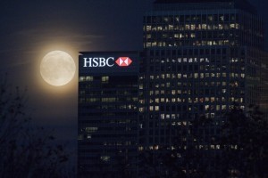 The moon rises behind HSBC bank in London's Docklands on November 13, 2016. Tomorrow, the moon will orbit closer to the earth than at any time since 1948, named a 'supermoon', it is defined by a Full or New moon coinciding with the moon's closest approach to the Earth. / AFP PHOTO / JUSTIN TALLIS