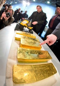 Gold ingots are on display during a press conference of Germany's Central Bank in Frankfurt, Wednesday Jan. 16, 2013.  Germany's central bank is to bring back home some US $36 billion ( 27 billion euro)  worth of gold stored in the United States and France. The Bundesbank said in a statement Wednesday that it will repatriate all 374 tons of gold it had stored in Paris by 2020. An additional 300 tons - equivalent to 8 percent of the Bundesbank's total reserves worth about US  $183 billion  will also be shipped from New York to Frankfurt. Frankfurt will hold half of Germany's 3,400 tons of gold by 2020, with New York retaining 37 percent and London storing 13 percent.  The move follows criticism from Germany's independent Federal Auditors' Office last year bemoaning the central bank's oversight of gold reserves abroad.(AP Photo/ dpa/ Frank Rumpenhorst)