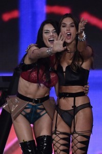Brazilian model Adriana Lima (L) and Brazilian model Alessandra Ambrosio cheer during the 2016 Victoria's Secret Fashion Show at the Grand Palais in Paris on November 30, 2016.  / AFP PHOTO / Martin BUREAU / RESTRICTED TO EDITORIAL USE