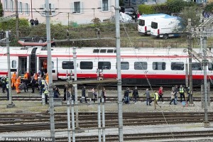 Rescuers help passengers next to a derailed train in the station of Lucerne, Switzerland, Wednesday, March 22, 2017. Swiss police say they are trying to reach people trapped inside the train in the  city of Lucerne, with details of any injuries still unclear. Rail company SBB says the Milan to Basel train derailed Wednesday as it was pulling out of Lucerne’s main train station.   (Urs Flueeler/Keystone via AP)