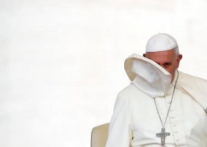A gust of wind blows off Pope Francis' mantle during the weekly audience in Saint Peter's Square at the Vatican. REUTERS/Tony Gentile