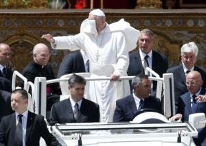 A gust of wind blows Pope Francis' mantle as he leaves at the end of a mass in Saint Peter's Square at the Vatican. REUTERS/Tony Gentile