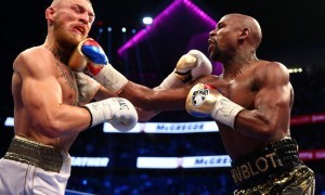 Aug 26, 2017; Las Vegas, NV, USA; Floyd Mayweather Jr. lands a hit against Conor McGregor during a boxing match at T-Mobile Arena. Mandatory Credit: Mark J. Rebilas-USA TODAY Sports