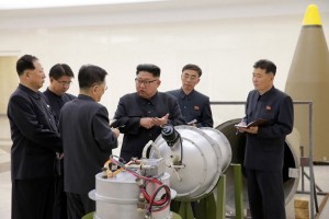 This undated picture released by North Korea's official Korean Central News Agency (KCNA) on September 3, 2017 shows North Korean leader Kim Jong-Un (C) looking at a metal casing with two bulges at an undisclosed location. North Korea has developed a hydrogen bomb which can be loaded into the country's new intercontinental ballistic missile, the official Korean Central News Agency claimed on September 3. Questions remain over whether nuclear-armed Pyongyang has successfully miniaturised its weapons, and whether it has a working H-bomb, but KCNA said that leader Kim Jong-Un had inspected such a device at the Nuclear Weapons Institute. / AFP PHOTO / KCNA VIA KNS / STR / South Korea OUT / REPUBLIC OF KOREA OUT   ---EDITORS NOTE--- RESTRICTED TO EDITORIAL USE - MANDATORY CREDIT "AFP PHOTO/KCNA VIA KNS" - NO MARKETING NO ADVERTISING CAMPAIGNS - DISTRIBUTED AS A SERVICE TO CLIENTS THIS PICTURE WAS MADE AVAILABLE BY A THIRD PARTY. AFP CAN NOT INDEPENDENTLY VERIFY THE AUTHENTICITY, LOCATION, DATE AND CONTENT OF THIS IMAGE. THIS PHOTO IS DISTRIBUTED EXACTLY AS RECEIVED BY AFP.  /