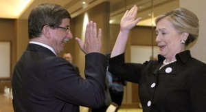 U.S. Secretary of State Hillary Clinton gives Turkey's Foreign Minister Ahmet Davutoglu a high five at the start of their bilateral meeting at the Emirates Palace Hotel in Abu Dhabi June 9, 2011.   REUTERS/Susan Walsh/Pool   (UNITED ARAB EMIRATES - Tags: POLITICS)
