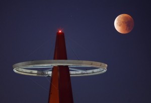 epaselect epa06488242 A so-called 'Supermoon' shines its blood red colors during a full eclipse above the Big A Sign of Angel Stadium in Anaheim, California, USA, 31 January 2018, during the last time in a series of three consecutive 'Supermoons', dubbed the 'Supermoon Trilogy'.  The previous 'Supermoons' appeared on 03 December 2017 and on 01 January 2018. A 'Supermoon' commonly is described as a full moon at its closest distance to the earth with the moon appearing larger and brighter than usual.  EPA/EUGENE GARCIA