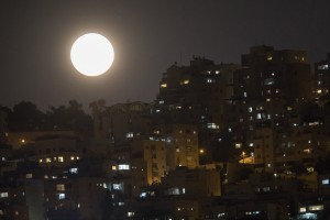 epa06488367 A so-called 'Supermoon' rises above the neighbourhood of Har Nof in the city of Jerusalem, Israel, 31 January 2018, during the last time in a series of three consecutive 'Supermoons', dubbed the 'Supermoon Trilogy'. The previous 'Supermoons' appeared on 03 December 2017 and on 01 January 2018. A 'Supermoon' commonly is described as a full moon at its closest distance to the earth with the moon appearing larger and brighter than usual.  EPA/JIM HOLLANDER
