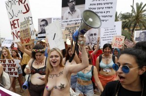 EDITORS NOTE: Graphic content / Participants of the annual "SlutWalk" march through the Israeli Mediterranean coastal city of Tel Aviv on May 4, 2018 to protest against rape culture, including sexual assault and harassment directed at women. The campaign, which has gained international notoriety, was inspired by group of Canadian women who launched the protest in 2011 in response to a policeman's comment that if women want to avoid being attacked they should not dress like sluts. / AFP PHOTO / JACK GUEZ