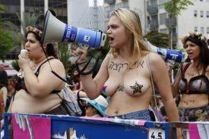 Participants of the annual "SlutWalk" march through the Israeli Mediterranean coastal city of Tel Aviv on May 4, 2018 to protest against rape culture, including sexual assault and harassment directed at women. The campaign, which has gained international notoriety, was inspired by group of Canadian women who launched the protest in 2011 in response to a policeman's comment that if women want to avoid being attacked they should not dress like sluts. / AFP PHOTO / JACK GUEZ