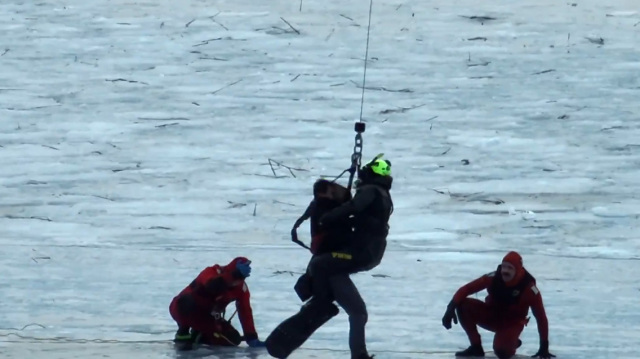 Dramatic helicopter rescue of three men who fell into a frozen lake in ...